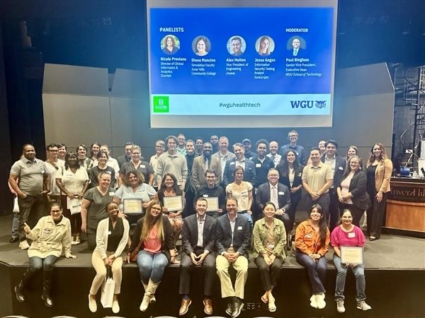 A group photo of participants and speakers at a WGU event.