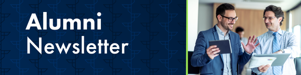 Alumni Newsletter featuring two smiling businessmen discussing documents and a tablet.