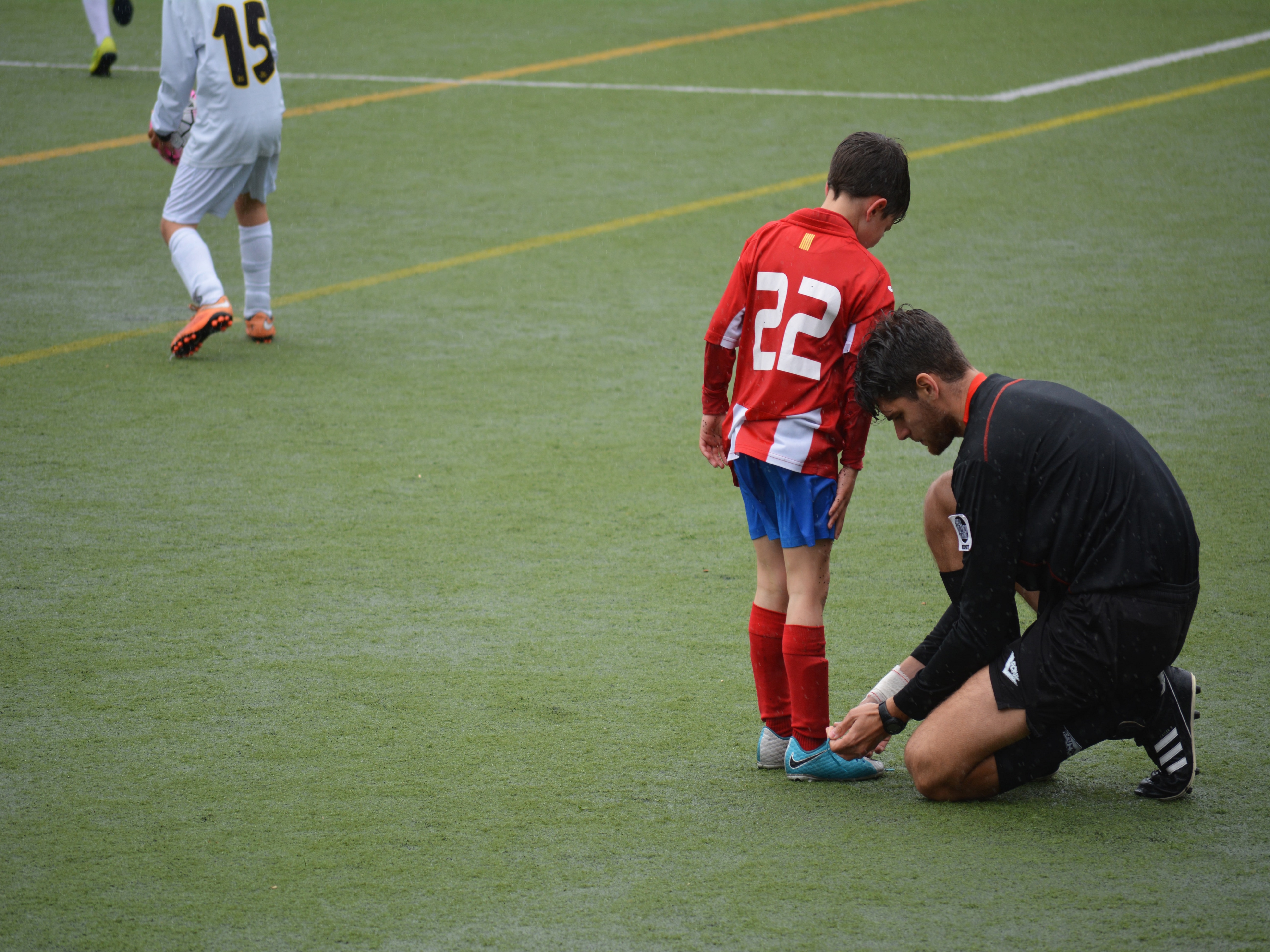 Adult helping kid with shoe