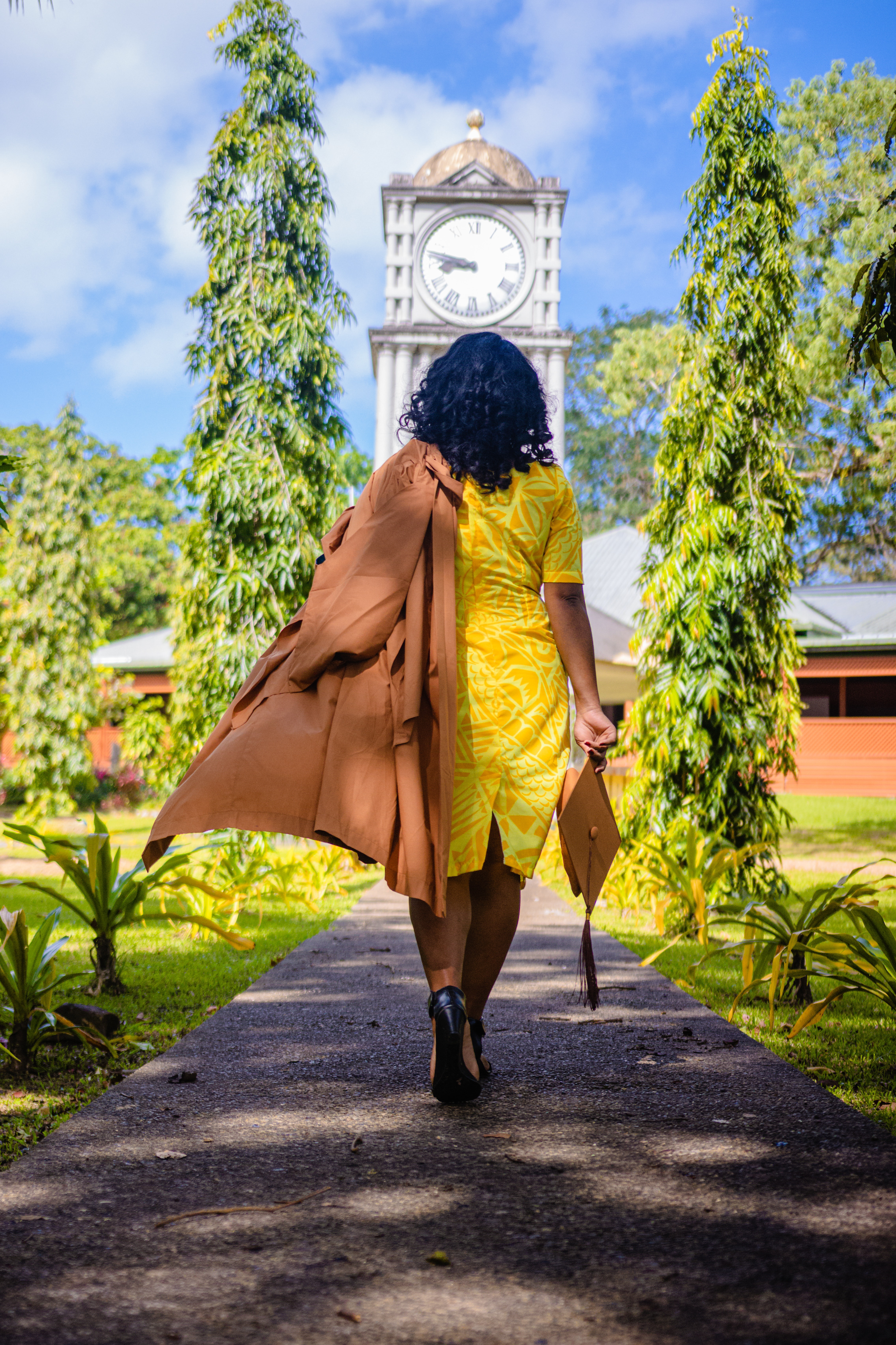 woman with grad cap in hand