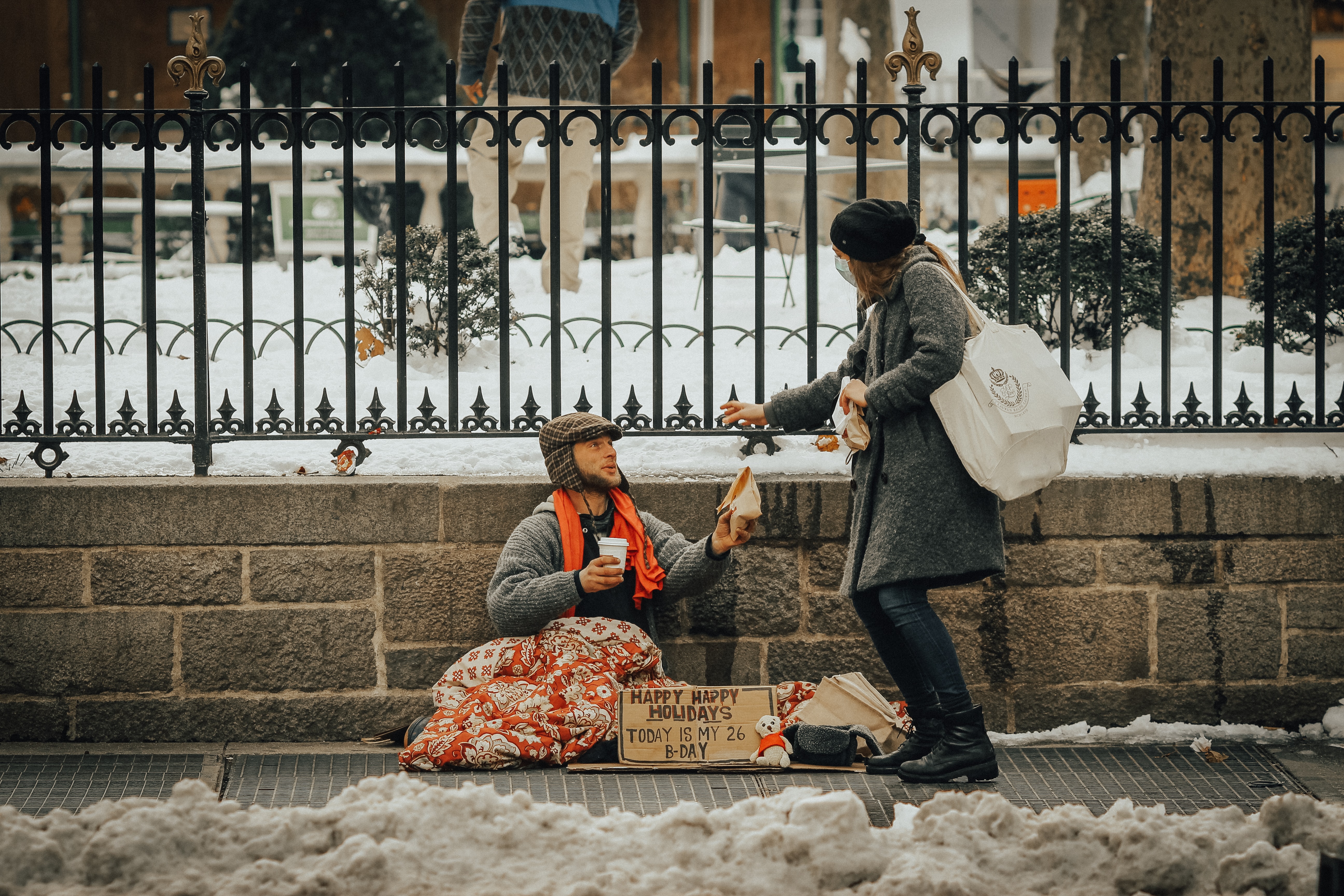 Woman helping homeless person