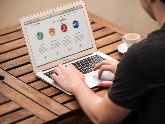 man using laptop for resources